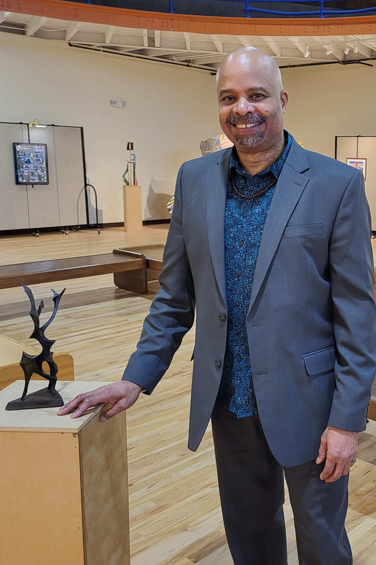 Stephen Tyson standing near sculpture inside The Rise Gallery