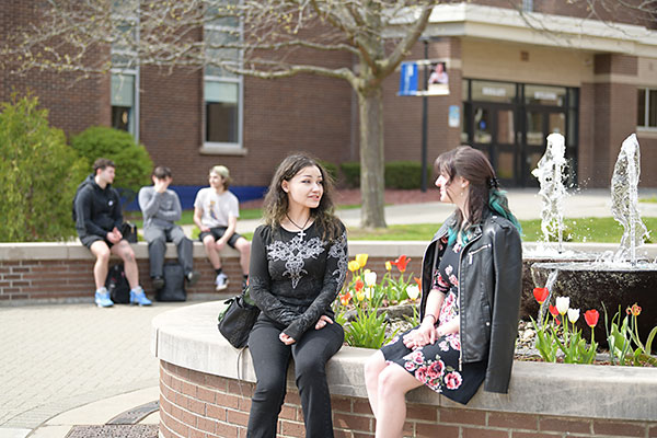 Students sitting in the Quad, talking.