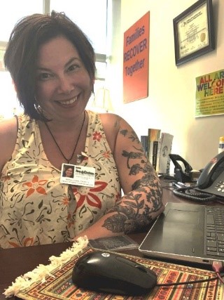 Martina Swiers sitting at her desk in an office setting.