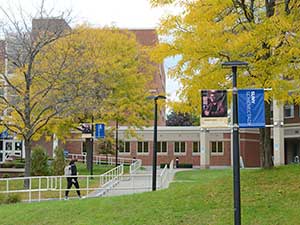 Student walking through the Quad toward Elston Hall. 