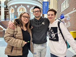 Three students standing together in the commons.