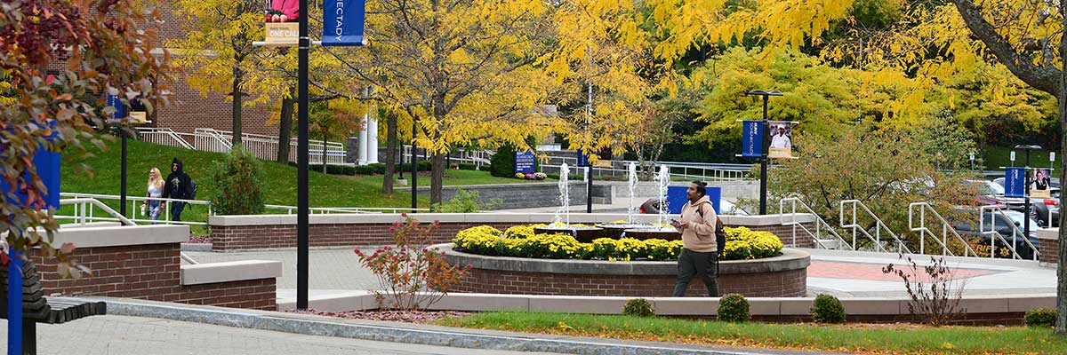 The Quad with students walking past the fountain.