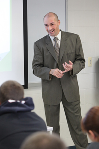 Matt Farron at the front of a classroom full of students.