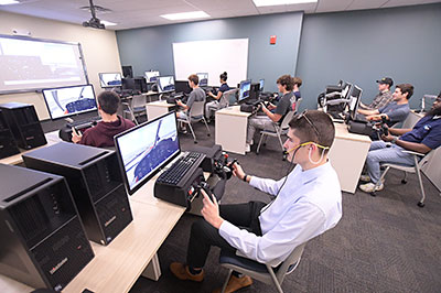 Students working on the flight simulators in the STEM Aviation Lab. 