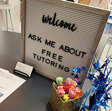 Letterboard sign that says, "Welcome, ask me about free tutoring."