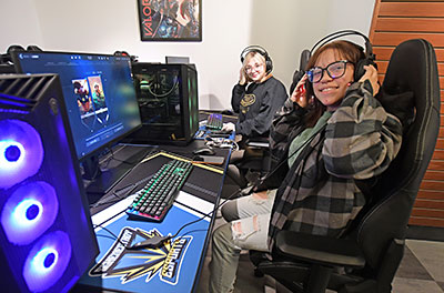 Two students in the eSports arena, seated at computers.  