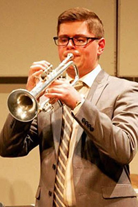 Jake DiMirra playing a trumpet.