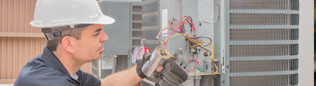 Repair technician working on an air conditioning system. 