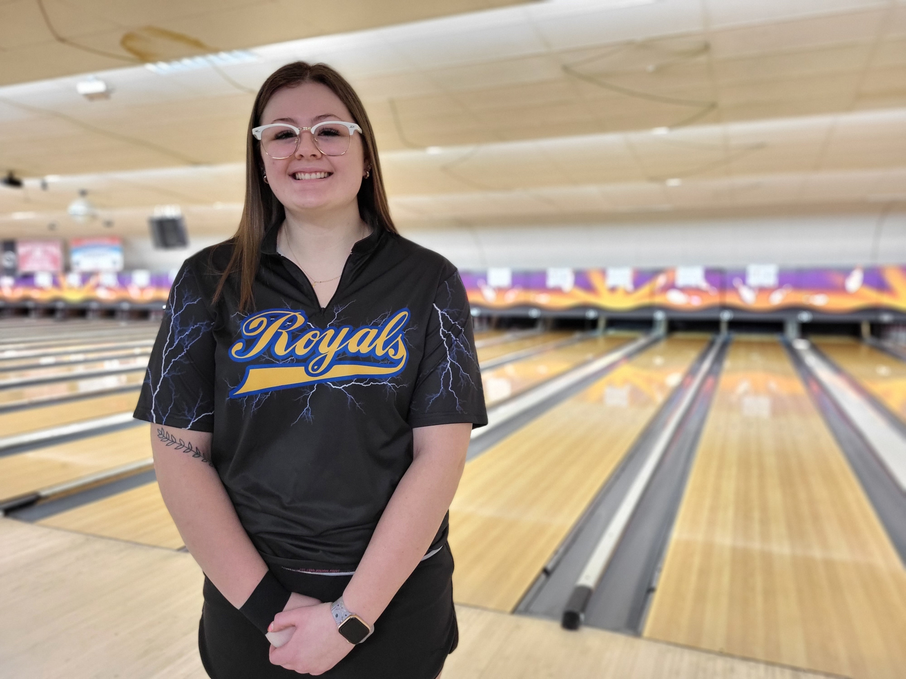 Eliza Arasim smiling, standing in Boulevard Bowl